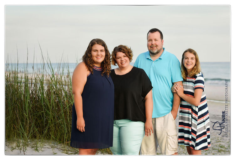 Family of 4 beach session at Santa Rosa, Florida on the emerald coast with sea grass and ocean waters on white sandy beach.